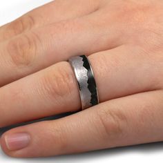 Say "I do" with a bang with this out of this world meteorite mountain ring with crushed dinosaur bone! Featuring a a bold mountain design and a dinosaur bone inlay made from a million-year-old fossil, this alternative wedding band is sure to make your special day and every day extra special. RING LAYOUTRing Width: 8 mmRing Sleeve: TitaniumRing Profile: FlatRing Finish: Polished 0.5 mm Titanium3.5 mm Crushed Dinosaur Bone3.5 mm Gibeon Meteorite (Jagged Mountain Design)0.5 mm Titanium Dinosaur Bone Jewelry, Gibeon Meteorite, Alternative Wedding Bands, Meteorite Jewelry, Mountain Ring, Jewelry By Johan, Mountain Design, Engraving Fonts, Bone Jewelry