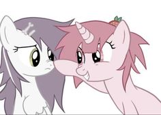 two pinkie ponies are touching each other's noses while one looks at the camera