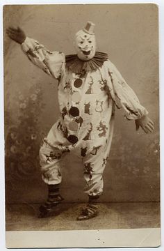 an old photo of a clown with his arms out