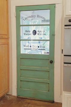 a green door in the corner of a kitchen with an advertisement for laundry room on it