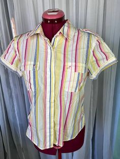 button up shirt striped bright red pink yellow cotton Size medium hidden button front. does have a small stain on back left.  Be aware that vintage sizes may vary from modern standard sizes. See the sizely chart in the product photos for full measurements. The measurements are the most accurate gauge of the garments size. chest, waist and hip measurements are taken laying flat and then doubled. all measurements are approximate.  Vintage items are carefully inspected and I do my best to describe all flaws. but all vintage items may have unnoticed flaws and signs of wear from being preloved. Pink Casual Shirt With Vertical Stripes, Casual Pink Shirt With Vertical Stripes, Red Cotton Shirt With Vertical Stripes, Pink Vertical Stripes Button-up Top, Pink Vertical Striped Button-up Top, Multicolor Short Sleeve Shirt With Vertical Stripes, 80s Shorts, Star Buttons, Empire Waist Dress