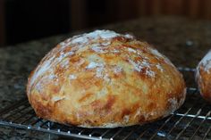 two loaves of bread sitting on a cooling rack