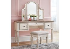 a white vanity with mirror and stool in front of pink wallpapered room area