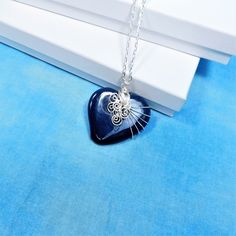 A Blue ceramic heart is artistically hand wire wrapped with non tarnish fine silver over copper wire to create a one of a kind pendant. he heart measures 1 3/4 inches by 1 3/4 inches and comes with a FREE coordinating chain with lobster claw clasp,measured to your preferred length. Your unique pendant necklace is ready to ship via USPS to your US location at no extra cost. (International shipping available. Please be aware of your local laws related to customs and VAT.) Handmade Heart Pendant Necklace, Handmade Wire Jewelry Gift, Wire Wrapped Heart Pendant Necklace For Valentine's Day, Wire Pendant Necklace For Gift, Valentine's Day Wire Wrapped Heart Pendant Necklace, Wire Pendant Necklace As A Gift, Valentine's Day Heart Pendant Necklace, Wire Wrapped, Hand Wrapped Heart Pendant Jewelry Gift, Heart-shaped Wire Wrapped Necklace For Gift