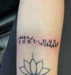 a tattoo with the words contin nue and a lotus on it's arm