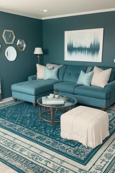 a living room with blue couches and rugs on the floor in front of a painting