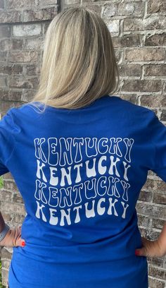 New Retro Kentucky shirt! Vintage Kentucky design with smiley face on front left chest!  Unisex Sizing!  🔹T SHIRTS🔹 Toddler 2T-5T Youth XS- Youth XL Adult S-XL Adult 2X Adult 3X 🔹LONG SLEEVE & SWEATSHIRTS🔹 Toddler 2T-5T Youth XS- Youth XL Adult S-XL Adult 2X Adult 3X If you would like to request a custom order,   please send us a message! Blue Pre-shrunk T-shirt For Everyday, Fun Graphic Print T-shirt For College, Casual Pre-shrunk Shirt For Fan Merchandise, Casual Pre-shrunk Shirt For Fans, School Spirit Top With Logo Print And Relaxed Fit, Fun Crew Neck Tops For College, Fun Graphic Print Tops For College, Casual Fan Merchandise Shirt With Text Print, Pre-shrunk Blue T-shirt For Everyday Wear