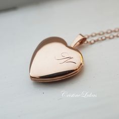 "Own this beautiful heart locket necklace and personalize it with your single Initial in pretty script font. Insert 2 photos for lifetime memories. Perfect gift for birthday, Mother's Day, graduation, Christmas and etc. Metal options: *Sterling Silver *Sterling Silver with Gold overlay *Sterling Silver with rose Gold overlay Locket size shown on photo: 0.8\" locket shape: Heart  Chain: cable -------SHIPPING--------- Allow 10-15 business days for production." Rose Gold Heart Locket, Rose Gold Locket, Locket Design, Engraved Locket, Gold Heart Locket, Script Initial, Pearl Necklace Designs, Real Gold Jewelry, Heart Locket Necklace