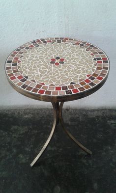 a small table with a mosaic design on it