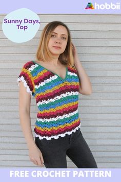 a woman standing in front of a wall wearing a crochet top