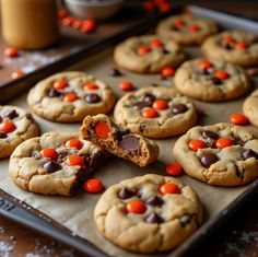 chocolate chip cookies with candy on top are ready to go into the oven for baking