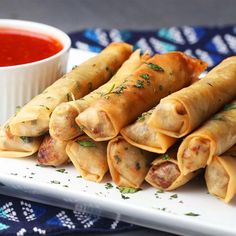 some food is sitting on a white plate and next to a small bowl of sauce