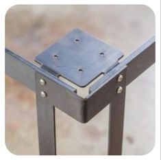 a metal table that has holes in the top and sides on each side, with one section missing