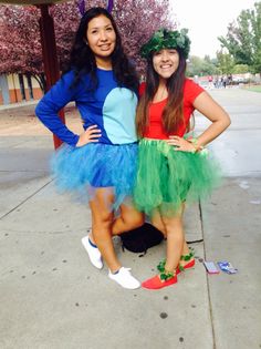 two women dressed up in costumes posing for the camera