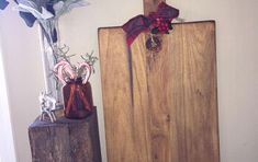 two wooden blocks with decorations on them in a corner next to a vase filled with flowers