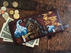 a wallet sitting on top of a wooden table filled with money