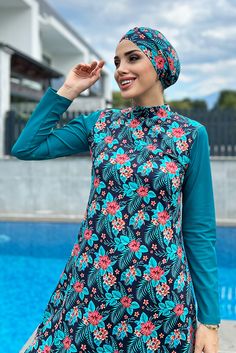 This floral printed veiling swimsuit is a perfect combination of blue and pink, giving it a feminine yet sporty look. Made with comfortable and stretchy lycra fabric, this set includes three pieces for complete coverage. Stretch Blue Swim Dress For Pool, Printed Fitted Sets For Poolside, Stretch Floral Print Swimwear For Beach Season, Fitted Printed Sets For Poolside, Blue Stretch Swim Dress For Swimming, Fitted Printed Beachwear Sets, Blue Stretch Swim Dress, Floral Print Stretch Swimwear For Beachwear, Stretch Floral Print Swimwear For Beachwear