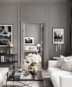 a living room with gray walls and white furniture