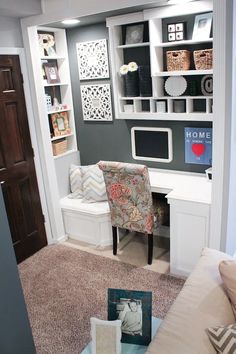 a living room with a couch, chair and bookshelf on the wall in front of it