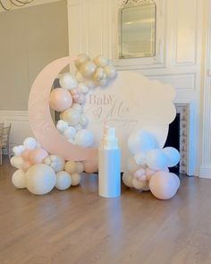 a baby shower is set up on the floor with balloons and candles in front of it