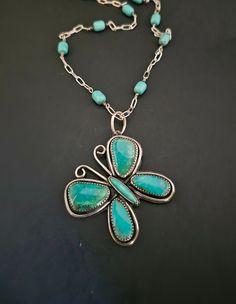 "Handmade turquoise jewelry.  This is created with sterling silver.  And a beautiful collection of genuine turquoise.  The wings of this design is with Nacozari and Kingman turquoise.  The high dome body is a beautiful Tyrone turquoise.  I chose to make the chain for this piece.  Giving it a beautiful personal touch.  Adding fantastic #8 turquoise beads. This piece is a gorgeous one of a kind.  Built with fabulous mined turquoise.   A design to enjoy for many years to come.  21\" in length  See pictures for size reference.  Ready to ship." Turquoise Necklace With Patina As A Gift, Artisan Turquoise Necklace With Inlay, Turquoise Pendant Necklace With Inlay, Handmade Sterling Silver Turquoise Necklace, Southwestern Turquoise Inlay Necklace, Unique Turquoise Nickel-free Necklace, Unique Nickel-free Turquoise Necklace, Handmade Turquoise Jewelry, Turquoise Butterfly