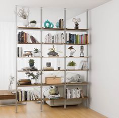 a bookshelf filled with lots of books next to a window