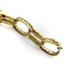 This vintage 18k gold bracelet is reminiscent of childhood paper garlands, but in the most sophisticated sense! The links are oval loops, concave to add even more dimensionality, with an ornate pattern that reads like brocade. The pattern is abstract but catches the light and adds real beauty to the piece. The brocade feels similar to a Florentine finish and gives the bracelet a lovely glow. The curved, concave nature of the links allows them to lie into each other nicely, which is what makes the bracelet seem so fluid. When worn, the bracelet flows up and down, riding gracefully on the wrist.  The bracelet is 7 7/8”, but because of the open links, fits like slightly smaller size. A link could easily be removed to fit a smaller wrist, which would take the length down by 3/4”. Each link is Luxury Gold Bracelet With Oval Link, Luxury Gold Oval Link Bracelet, Antique Yellow Gold Link Bracelet, Luxury Oval Link Chain Bracelet For Anniversary, Gold Oval Link Oyster Bracelet Gift, Elegant Oval Link Brass Chain Bracelet, Yellow Gold Link Bracelet In Brass, Hammered Yellow Gold Oval Link Jewelry, Yellow Gold Hammered Oval Link Jewelry