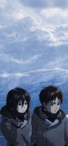 two people standing next to each other in front of snow covered mountains with clouds behind them