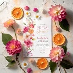 the bridal shower is surrounded by flowers and oranges