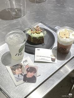 there is a cake and two drinks on the table next to each other with pictures