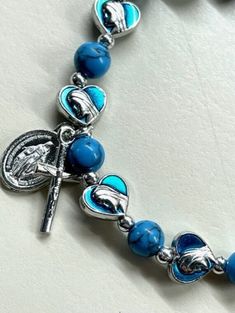 "Welcome to my Shop \"CREATING STILL MOMENTS.\"   To see all my listings and offerings, please visit my shop at  https://www.etsy.com/shop/CreatingStillMoments?ref=sh-carousel-1  This Blessed Mother Heart bracelet features beautiful turquoise blue round beads and heart shaped Blessed Mother beads. This bracelet features a Miraculous medal and crucifix dangle. Thank you for your support of my small Business. Thank you for supporting my small business!" Light Blue Spiritual Bracelet As Gift, Nickel-free Spiritual Rosary Bracelet Gift, Personalized Blue Spiritual Bracelets, Personalized Blue Jewelry For Mother's Day, Blue Personalized Spiritual Bracelets, Spiritual Personalized Blue Bracelets, Adjustable Rosary Bracelet For Mother's Day Gift, Adjustable Spiritual Rosary Bracelet For Mother's Day, Spiritual Bracelets With Miraculous Medal As Gift