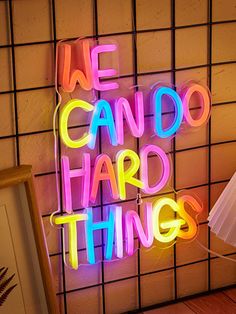 a neon sign that says we can do hard things on the side of a wall