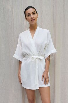 Inspired by our founders' first trip to Bali, the Bali Robe embodies our "bedroom to beach" concept. Crafted from lightweight fabric with a captivating texture reminiscent of rippled water. This versatile robe transitions seamlessly from home attire to beach cover-up, becoming a staple in your daily wardrobe. Drop Sleeve Relaxed fit Above the knee length Tie waist belt Pockets Linen Robe For Beach In Summer, Summer Wrap Robe For Lounging, Summer Beach Linen Robe, Summer Lounging Wrap Robe, Summer Relaxation Robe With Kimono Sleeves, Summer Sleep Robe In Wrap Style, Summer Relaxed Fit Robe For Loungewear, Summer Wrap Robe For Relaxation, Summer Linen Robe For Relaxation