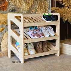 a wooden shoe rack with several pairs of shoes on it