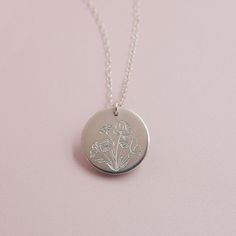 Our Wildflower necklace features a beautiful floral bouquet design engraved on the front, with the option to add a word, initials or a date on the back (or just keep it blank).DETAILS: 14kt gold filled or sterling silver choose chain length, model wearing 17" include back engraving instructions when ordering we can fit up to 8 characters on the back Wildflowers are said to symbolize joy and the idea that life doesn't always have to grow according to plan to still be quite beautiful. Celebrate so