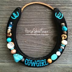 a cowgirl horseshoe shaped necklace with turquoise and white beads