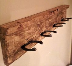 a wooden coat rack with five hooks on it