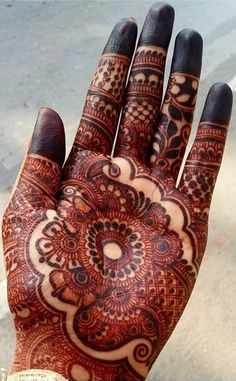 a person's hand with henna on it