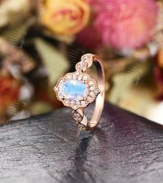 Moonstone Engagement Ring Rose Gold engagement ring Vintage Unique Wedding Oval Cut Bridal Set Milgrain Anniversary Jewelry Gift for Women Years of love story: https://www.etsy.com/shop/GemsOdes ▶ Watch Our Video about this ring: https://www.youtube.com/watch?v=icmu9HsyAhA 「Product Summary」 -center stone:5*7mm Moonstone -side stone: 0.18ct Diamond(G-H; VS-SI) -total weight:3.16g -shank thickness:1.1mm -shank width:1.8mm ◆Made of 14k /18k - Rose / White / Yellow Gold ◆All sizes are available, con Rose Gold Wedding Ring With Oval Cabochon, Heirloom Oval Cabochon Jewelry For Wedding, Wedding Jewelry With Oval Cabochon Rose Cut Diamonds, Wedding Jewelry With Rose Cut Oval Cabochon Diamonds, Rose Gold Halo Moonstone Ring For Wedding, Oval Halo Wedding Jewelry, Oval Halo Jewelry For Wedding, Heirloom Oval Cabochon Moonstone Wedding Ring, Oval Halo Design Jewelry For Wedding