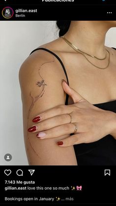 a woman's arm with tattoos on it and her hand holding the other arm