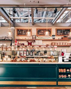 the inside of a bakery filled with lots of food