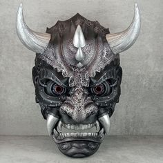 ⭐Name -  Сyber demon mask 💥Application - Wearable mask, can be used as interior decoration 🎨Color - black and silver 🖨️Production - 3D printing 🧵Material -Material - PLA plastic 🖌️Coloring - acrylic paints and varnishes. 🔒 Fastening -  5 adjustable elastic bands that allow you to comfortably hold the mask on your head. ⚙️Features - the mask is equipped with a wall mounting system, which includes 2 plastic hooks for wall mounting and 2 brackets installed on the mask itself. The upper elastic band has a bracket for hanging the mask on a hook or carabiner. A seal is installed in the frontal part of the mask, ensuring comfortable wearing of the mask 📏Internal size: width (at eye level) 155mm height (without horns) 255mm (It is possible to make a mask of a different size) Mask Design - M Black Samurai Masks And Prosthetics For Cosplay, Cyberpunk Black Costume Mask, Samurai Style Black Mask For Masquerade, Black Warrior Masks And Prosthetics For Fantasy Events, Black Warrior Style Mask For Masquerade, Black Warrior Mask For Masquerade, Warrior Style Black Mask For Halloween, Black Warrior Style Masks For Masquerade, Warrior Style Black Masks And Prosthetics For Halloween