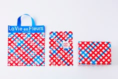 two red, white and blue bags sitting next to each other