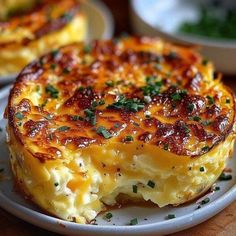 a close up of a slice of quiche on a plate with other dishes in the background