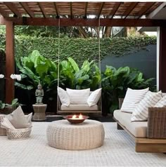 an outdoor living area with furniture and plants