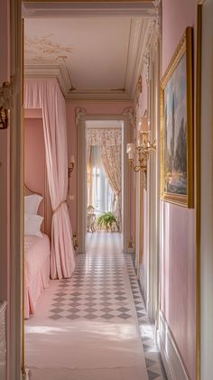 the hallway is decorated in pink and gold with chandeliers on either side of the bed