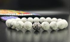 Discovered in Nova Scotia, "White Buffalo" stone has great calming properties. It will give you the gift of wisdom and enlightenment. Howlite's unique pourous texture feels great against the skin. Memory, Patience, Knowledge 10mm beads accented by a single 925 sterling silver focal bead White 108 Beads Jewelry As A Gift, White Agate Spiritual Jewelry, White Howlite Spiritual Jewelry, White Holistic Jewelry For Gifts, Elegant Beaded Bracelets For Meditation, Spiritual White Howlite Beaded Bracelets, Howlite Round Beads Jewelry Gift, Minimalist White Jewelry With 8mm Beads, White Gemstone Beaded Bracelets For Meditation