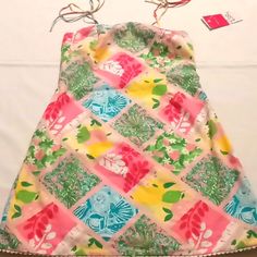 Lily Pulitzer Palm Beach Cocktail Dress. This Timeless Dress Is Perfect For Your Upcoming Vacation Or Celebration. With Spaghetti Straps And Zipper On The Side 100%Cotton Lining 65 %Polyester 35 %Cotton Machine Wash Cold. Dress Length 26" Color Bermuda Pink / Tiles Patch. Pink Tropical Mini Dress For Summer, Pink Tropical Print Sundress For Summer, Pink Sleeveless Tropical Print Mini Dress, Pink Sleeveless Tropical Sundress, Pink Sleeveless Tropical Mini Dress, Pink Sleeveless Mini Dress With Tropical Print, Pink Sleeveless Floral Print Beach Dress, Sleeveless Pink Floral Print Beach Dress, Pink Beach Season Vacation Dress