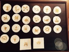 several different types of embroidered badges in a wooden frame on a wood table with white circles