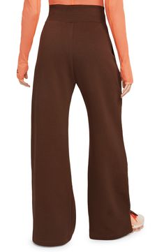 Get incredibly comfy in these wide-leg sweats with split hems so you can show off your favorite footwear. Taller ribbing at the waist, as well as an exaggerated drawcord, ensure the look is anything but basic. 28" inseam; 12" front rise (size Small) 80% cotton, 20% polyester Machine wash, tumble dry Imported Nike Sweatpants For Loungewear In Fall, Nike Sweatpants For Fall Loungewear, Wide Leg Sweatpants For Fall, Nike Full Length Sweatpants For Loungewear, Casual Nike Sweatpants For Fall, Nike Casual Sweatpants For Fall, Nike Casual Fall Sweatpants, Nike Athleisure Pants For Fall, Brown Wide Leg Sweatpants For Winter